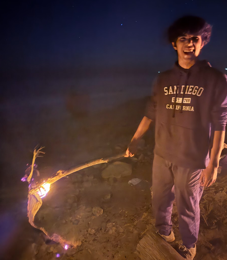 Holding a burning stick at night